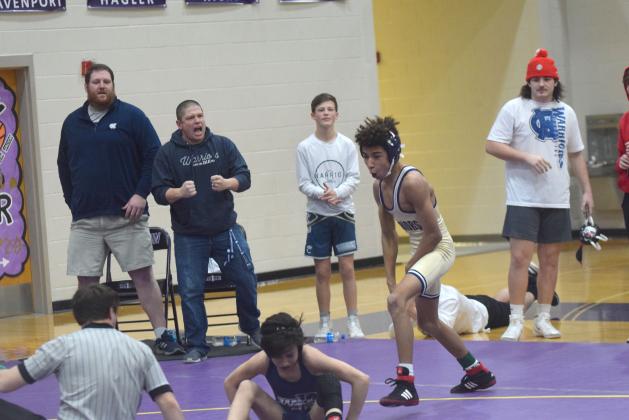 Isaiah Whitlow, right, and WCHS coaches Nathan Riddle, left, and Patrick Lowendick celebrate moments after Whitlow won the 106-pound championship match.