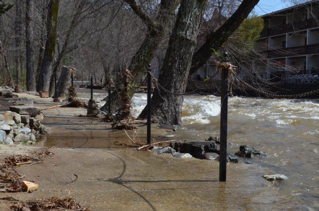 Even though it had gone down by Friday morning, the Chattahoochee River was still high and flowing onto the sidewalk in front of the Troll Tavern. (Photo/Stephanie Hill)
