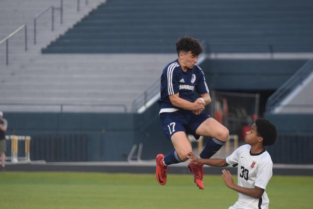 White County's Cohen Cantrell, left, goes up for a header during the Warriors' second round matchup with Greater Atlanta Christian Tuesday in Cleveland.