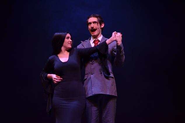 Ben Perrin, who plays Gomez Addams, and Ireland Ballington, who plays Morticia Addams, danced together during the opening number of dress rehearsals on Monday, April 19.