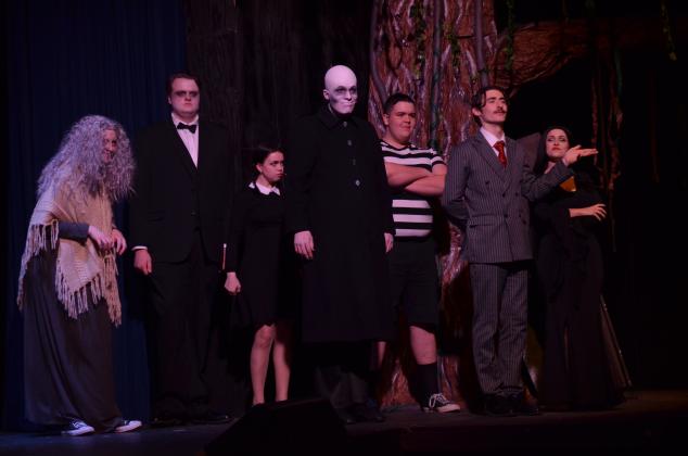 Pictured, from left to right, are Doni Martin as Grandma, Tim Behan as Lurch, Molly Cutchshaw as Wednesday Addams, Colin Baughman as Fester, Gabe Talafous as Pugsley, Ben Perrin as Gomez Addams, and Ireland Ballington as Morticia Addams, played their characters perfectly during dress rehearsal.