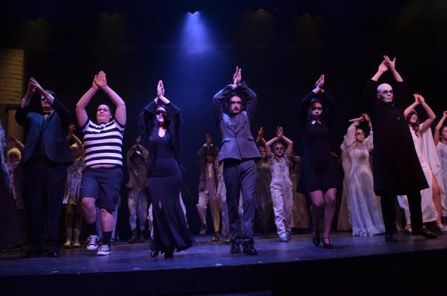 The cast of The Addams Family has a fun time dancing throughout the opening number of the show.