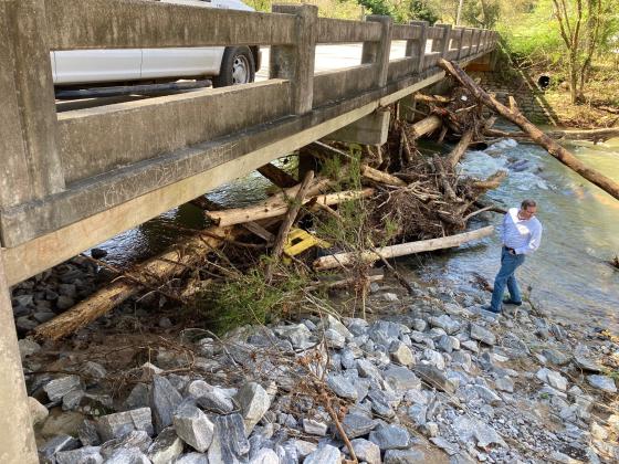 Darrell Westmoreland, building and zoning administrator in Helen, looks at the clog of trees and branches  at the Hamby Street Bridge in Helen. (Submitted photo)