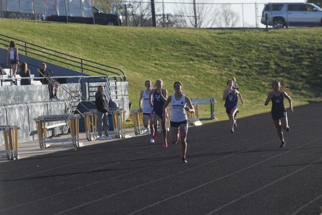 Lily Gearing won a pair of individual events to lead the track teams to the boy's and girl's team titles at the Warrior Invitational last Friday in Cleveland.