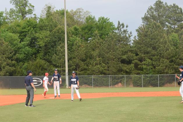 White County's Bailee Patterson, middle, and J. Ben Haynes, right, celebrate after turning a double play to end Game 1 of the Class AAA state baseball series last week in Sonoraville. (Photo/Mark Turner)