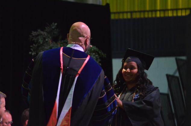 Clarissa Bran is greeted by TMU President Dr. Emir Caner as she walks the stage.