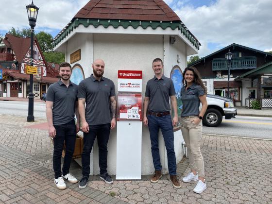Tyler Richie, Rex Burch, Chris Griesser and Sara Lezcano, with Student Doc for Shocks, pose with the new AED in the marketplatz in downtown Helen. (Photos/Stephanie Hill)