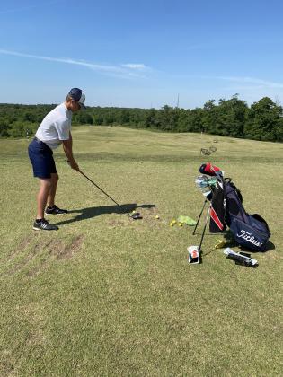 Jacob Adams gets in some work at the driving range  Monday morning before the start of the Class AAA state tournament in Hartwell. (Photo/WCHS Athletics)