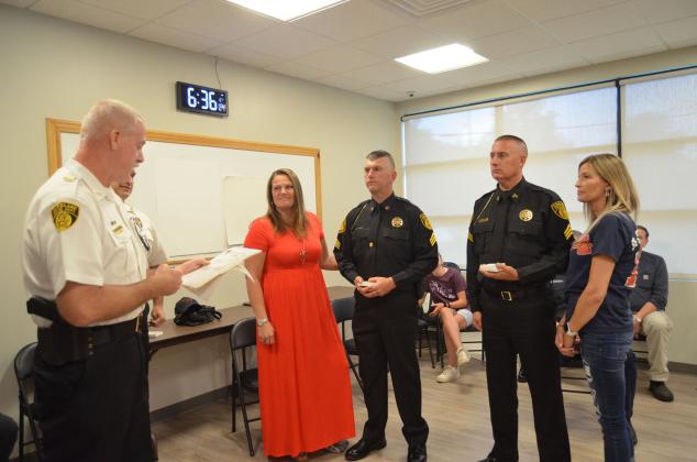 Two Cleveland Police Department officers were recently named sergeants. The recognition and pinning was held at the June 7 Cleveland City Council meeting. Police Chief Jeff Shoemaker (far left) is shown addressing the new sergeants, from left, Wesley Addis and Denton Vaughan. Addis’ wife, Sheila, and Vaughan’s wife, Amy, were on hand to assist with the pinning. (Photo/Wayne Hardy)
