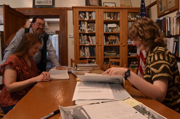 Bill Huff with the White County Historical Society assists Katelynn Comer and Brittany Mann with research. (Photo/Stephanie Hill)
