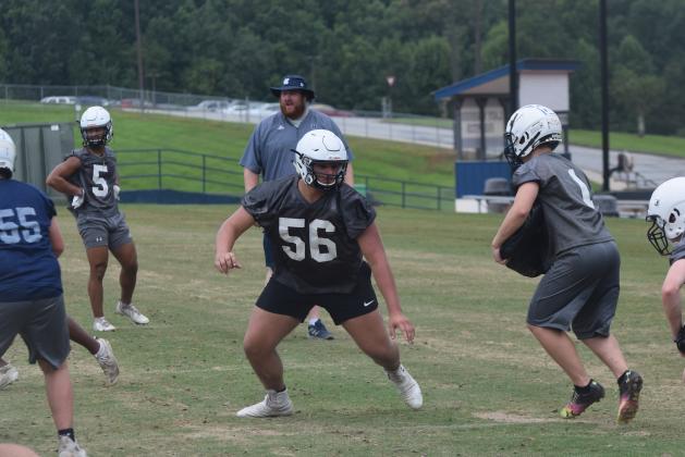 Offensive tackle JD Trowell, an All-Region pick last season, works during a team drill Tuesday at the Warriors' second acclimation practice session. (Photo/Mark Turner)