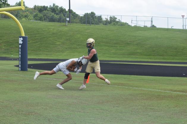 Kanaan Cleveland, left, shown hauling in a touchdown pass  during a 7-on-7 game earlier this summer, and the rest of the Warriors spent two day this week at an FCA Team Camp at Jacksonville State University in Alabama.  (Photo/Mark Turner)