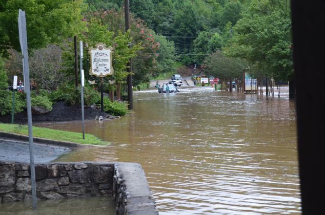A car got stuck in the water on Brucken Strasse in Helen, which was closed due to flooding. (Photo/Stephanie Hill)