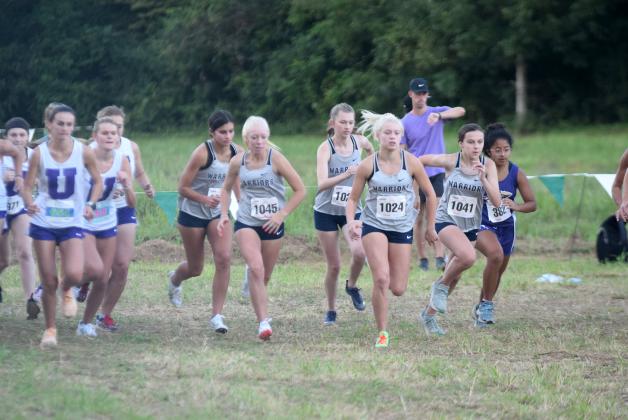 White County runners, from left, Lilly Gearing, Reese Vandegriff, Emily Davidson, Nealeigh Broadwell, and Emma Marrow, and Lumpkin County's Haley Souther break away the starting line last Thursday at the North Hall Invitational. (Photo/Mark Turner)
