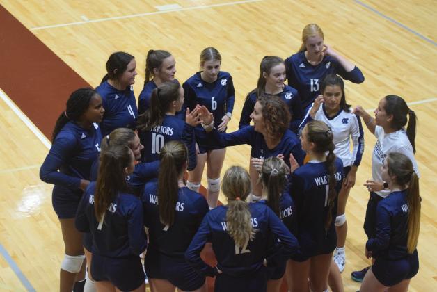 WCHS head coach Shannon Smith, center, talks the Lady Warriors during a recent match. WCHS will be back in action tonight with a tri-match at Jefferson High School. (Photo/Mark Turner)
