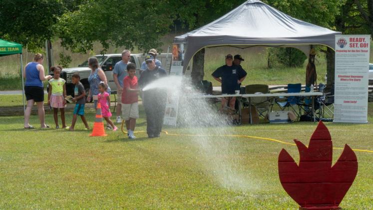 A youth had a chance to test out a fire hose with the help of a local firefighter at a previous Touch-A-Truck event.