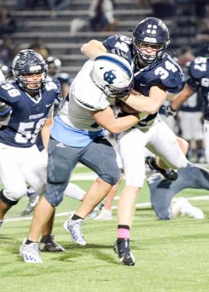 Alex Thornton, left, wraps up West Hall running back Blake McCray during the region win last Friday in Oakwood. (Photo/Staci Sulhoff)