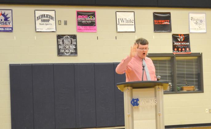 James King was among the members of a citizens group that have made claims that support for critical race theory is being allowed into the school system. King is shown punctuating his remarks by slapping his hand on the speaker’s podium.