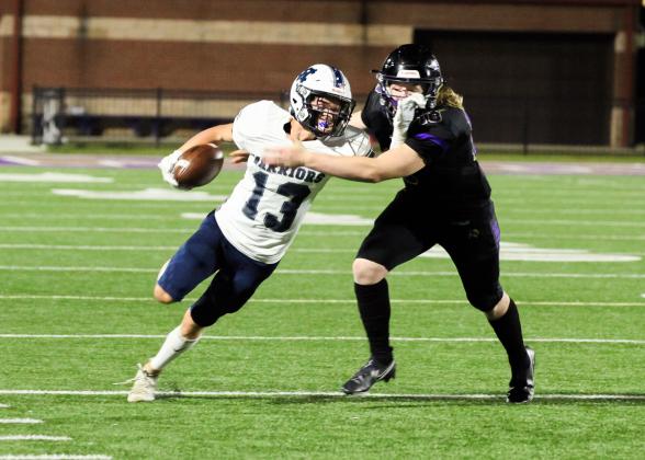 Colton Turner, left, tries to pull away from Lumpkin County's Cooper Scott after recovering a fumble during the Warriors' region win last Friday night in Dahlonega. (Photo/Staci Sulhoff)
