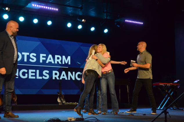 Community Care Pastor Cheryl Kennedy (left) gets a hug from Marie Allen of Whispering Angels Youth Ranch. Both groups were among the beneficiaries of the church’s Be Rich campaign. (Photo/Wayne Hardy)