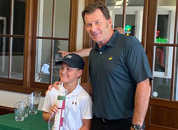 Hudson Justus, left, is shown with Master's champion Nick Faldo after winning the 10U division title last week at the Faldo Hurricane Series 2021 Grand Final. (Photo/Scott Justus)