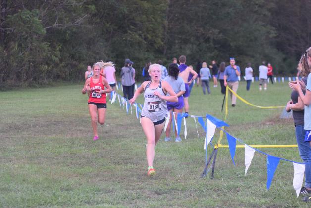 White County's Nealeigh Broadwell, right, pulls away from Rabun County's Molly Jo Wright during the final sprint to the finish line Tuesday at the Mountain Invitational at Unicoi State Park. (Photo/Mark Turner)