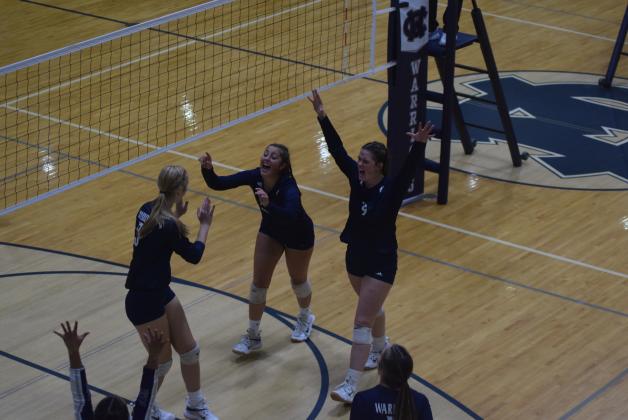 Claire Beckman, left, Linsey Burke, and Abbie Rankl celebrate a point during the Senior Night match against Tallulah Falls School. (Photo/Mark Turner)