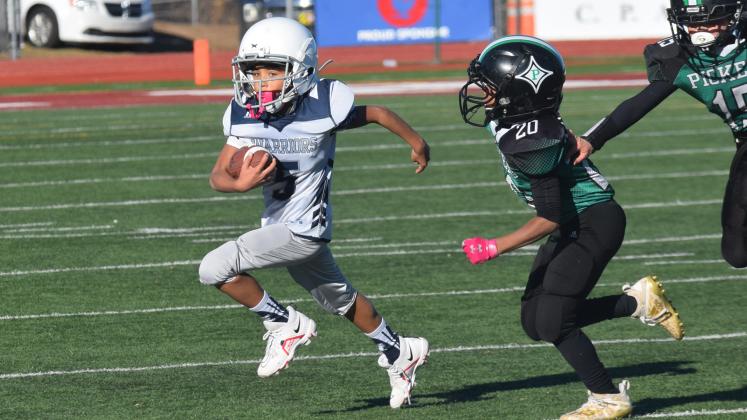 Cash Lowery heads toward the end zone during the fourth grade team's win. (Photo/Mark Turner)