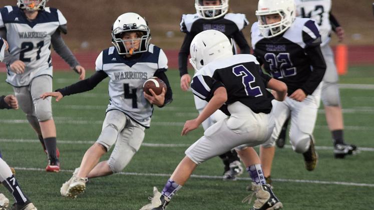 Lane Bray looks for some running room during the fifth grade game against Gilmer County. (Photo/Mark Turner)