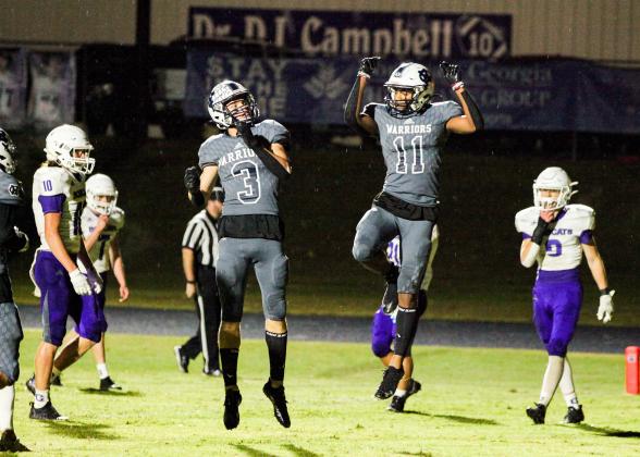 Bryson Cronic, left, and Darius Cannon celebrate after a touchdown during the Warriors' region win over Gilmer County last Friday in Cleveland. (Photo/Staci Sulhoff)