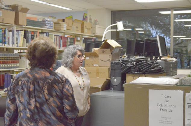 Library Children’s Director LaDonna Smith discusses the Cleveland library’s arrangement during the Oct. 28 gathering. She is shown next to boxes and equipment kept on top of a table due to lack or storage space. (Photo/Wayne Hardy)