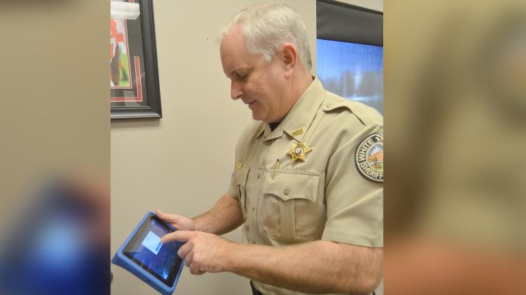 White County Sheriff Rick Kelley shows a smart tablet loaded with programs intended to address a variety of needs for inmates with the goal on reducing risk of recidivism.