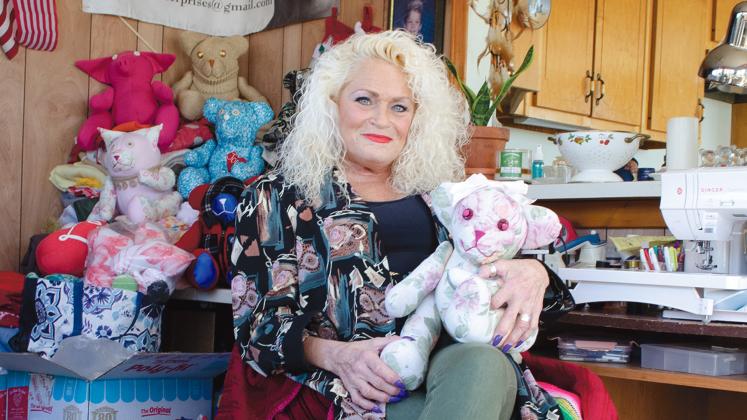 Laura Southerland holds one of the memorial teddy bears she creates for clients using the garments of loved ones who have died. She says demand for the keepsakes have continued to rise. (Photo/Ashley Blair)