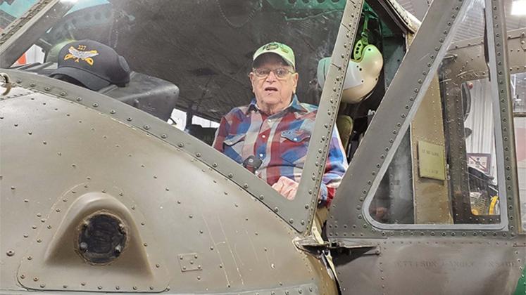 Veteran Don Vickery sits in his former helicopter, restored for display in Kentucky. Inset photo shows him while in service.