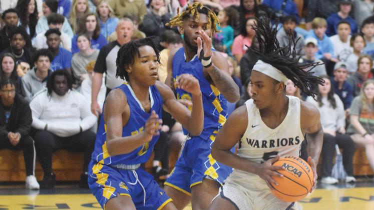 White County's Tavi Simmons, right, works against Beach's James Leach, left, and Jermaine Saxson during the Class AAA second round game Saturday in Cleveland. (Photo/Mark Turner)