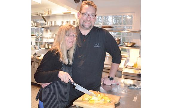 Laura Farrelly and Chris Bolton stand with a pile of sliced carrots in the renovated kitchen at Harvest Habersham, now open in Sautee Nacoochee. (Photo/Linda Erbele)