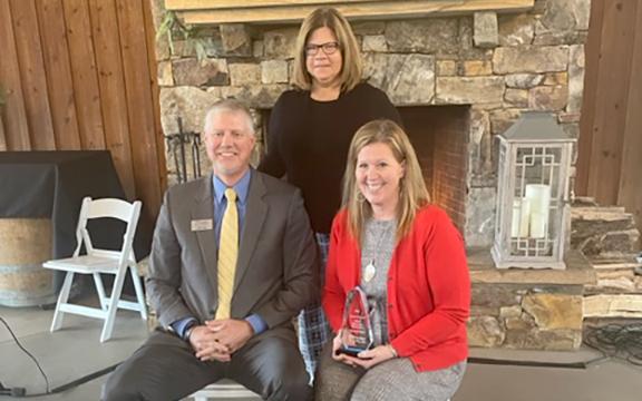 Pioneer RESA Executive Director Justin Old, along with Superintendent Laurie Burkett, honors Dr. MaryKay Berry as a Pioneer in Education.