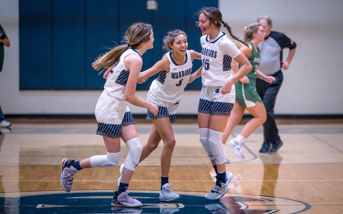 Kylie Watkins, left, and Naomi Roberts, right, celebrate with Aaliyah Anderson moments after Anderson hit a shot at the buzzer to knock off Pickens County 53-52 in a region matchup Tuesday in Cleveland. (Photo/Austin Barrera)