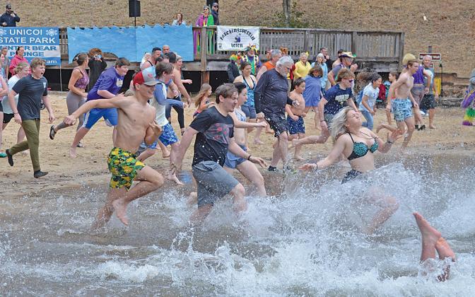 The crowd of 85 participants splash into Unicoi Lake for the annual Winter Bear Plunge Saturday morning. (Photo/Samantha Sinclair)