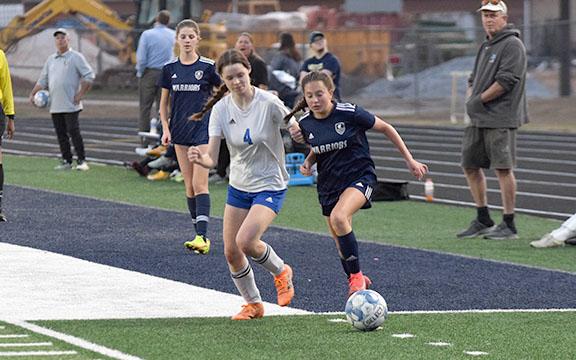 Isabella Moschiano, right, pushes the ball past a Banks County defender during the non-region win Monday night in Cleveland. (Photo/Mark Turner)