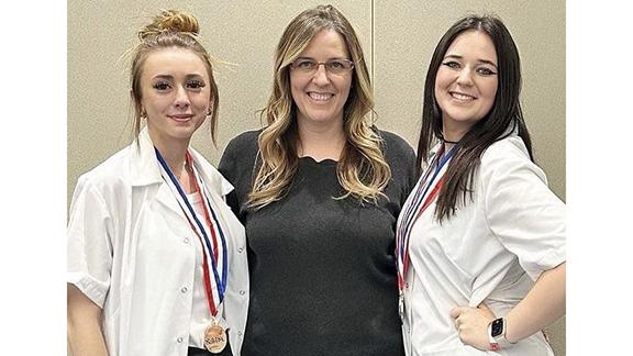 Lilly Vinson, Crystal Grier, and Caragin Grier celebrate first place wins in Cosmetology competitions.