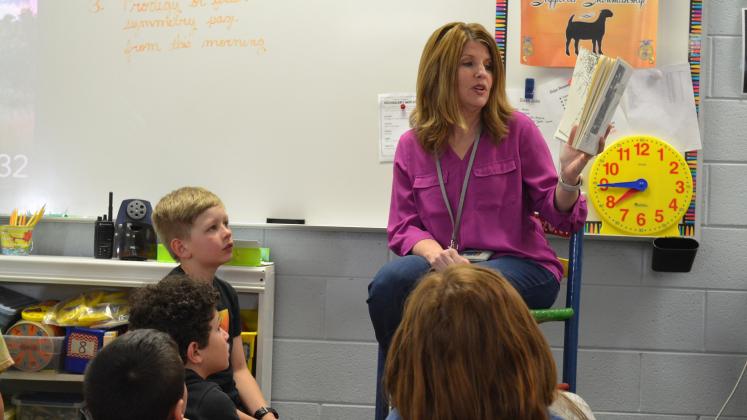 Mt. Yonah Principal Jill Baughman reads to a third grade class Friday afternoon. Many needed to give her hugs before she left the classroom.