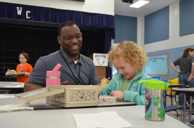 Tesnatee Gap Principal Octavius Mulligan shares a laugh with kindergartner Raleigh Brode in the cafeteria. (Photos/Samantha Sinclair)