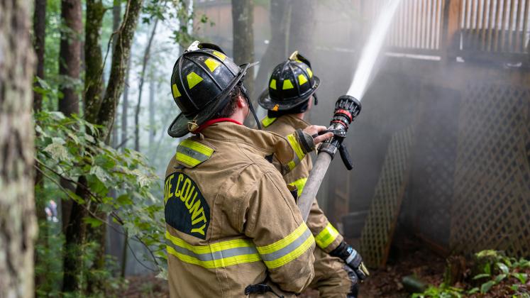 White County Firefighters and EMTs Frank Tirino and Jeffery Johansen work together to control the fire. (Photo/submitted)