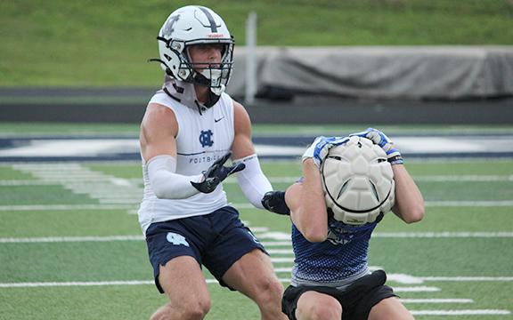 WCHS cornerback Caysen Duvall, left, closes in on a Fannin County receiver during the team's combined practice Wednesday morning at Warrior Stadium. (Photo/Mark Turner)