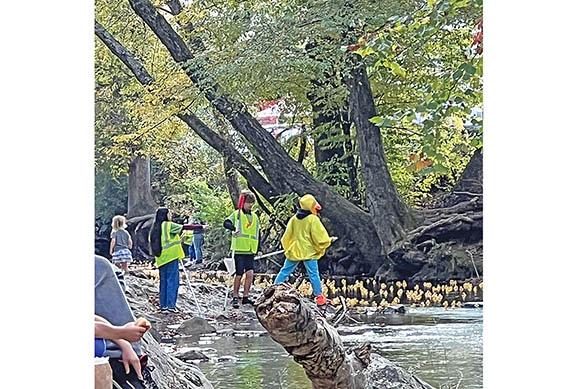 Volunteers watch over the ducks in last year’s Great Helen Duck Race. (file photo)