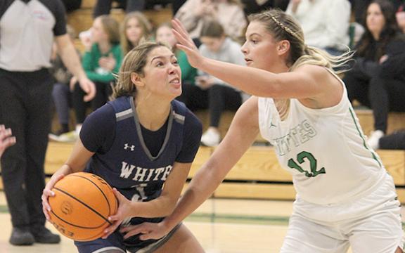 Aaliyah Anderson, left, works in the lane against Pickens' Isabella Hopkins during the region showdown Tuesday night in Jasper. (Photo/Mark Turner)