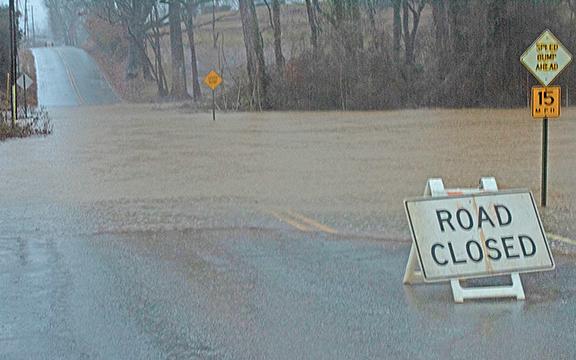 Rain water floods Quillian Street causing it to be closed Tuesday morning. (Photo/Noah Johnson)