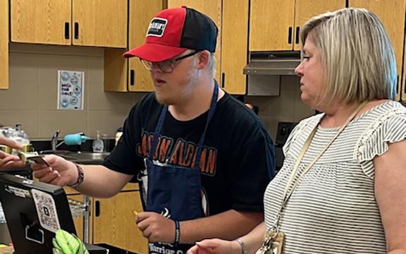 Nathan Anderson and Shauna Emig work as a team during the morning rush at the Warrior Cafe Coffee Cart. (Photo/Jane Grillo)