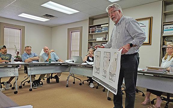 Stephen Fuller shows prototypical plans for Fuller Living housing units at a Cleveland Downtown Development Authority meeting in September. (File photo)
